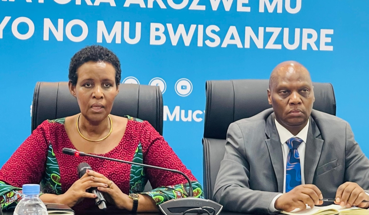 NEC Chairperson Oda Gasinzigwa speaks as Executive Secretary Charles Munyaneza looks on during a press conference in Kigali on Friday, August 30. 