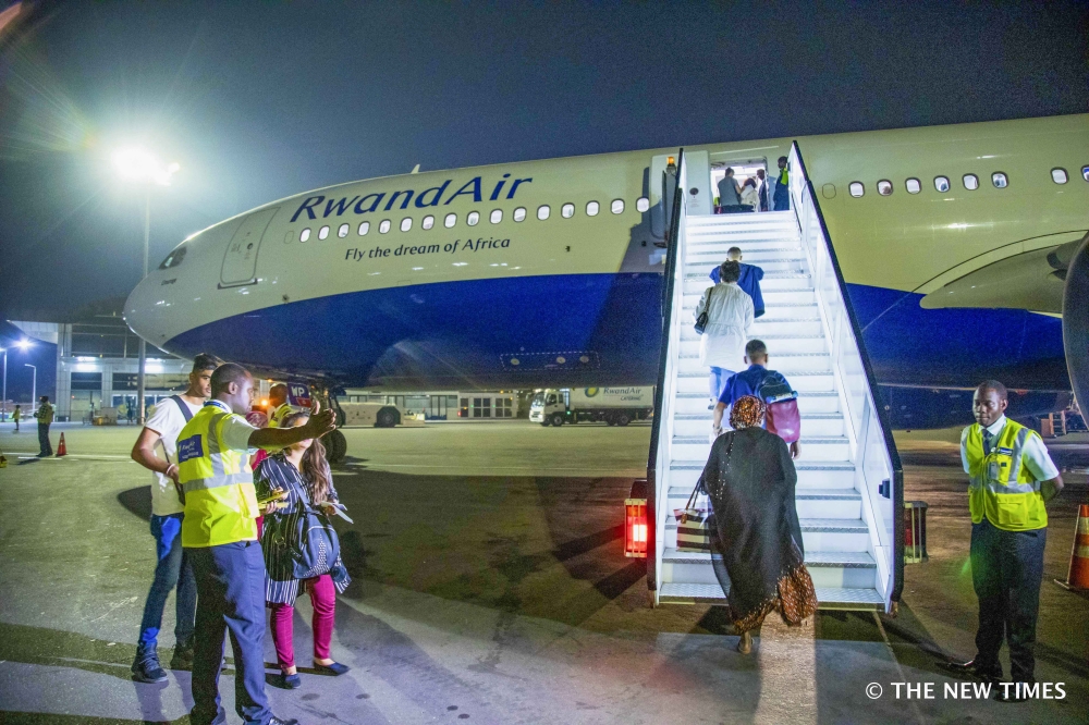 Passengers board a RwandAir plane at Kigali International Airport. File