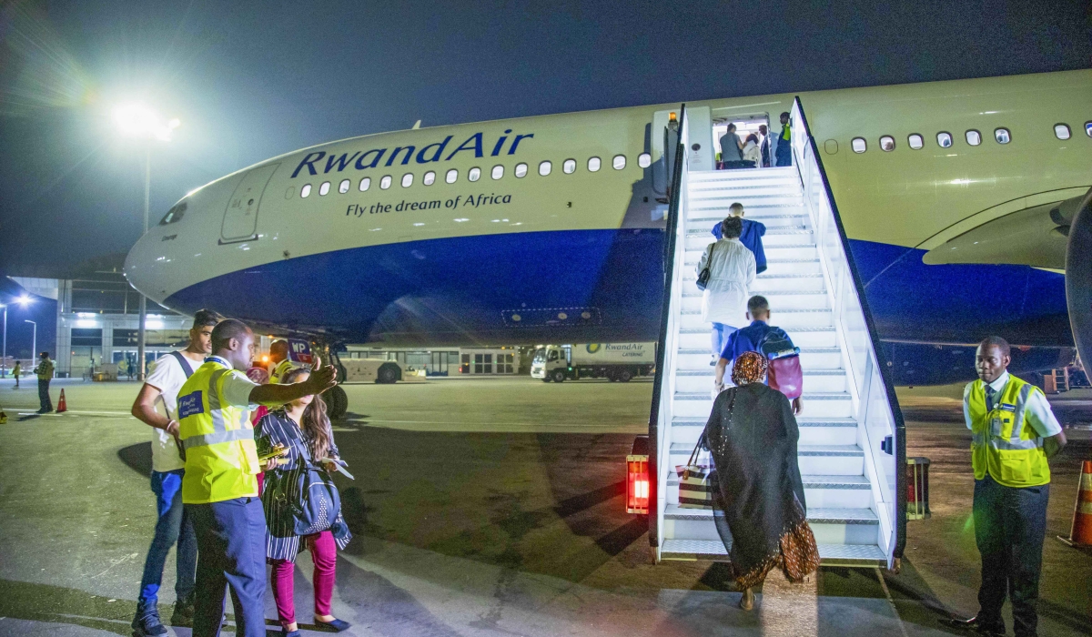 Passengers board a RwandAir plane at Kigali International Airport. File