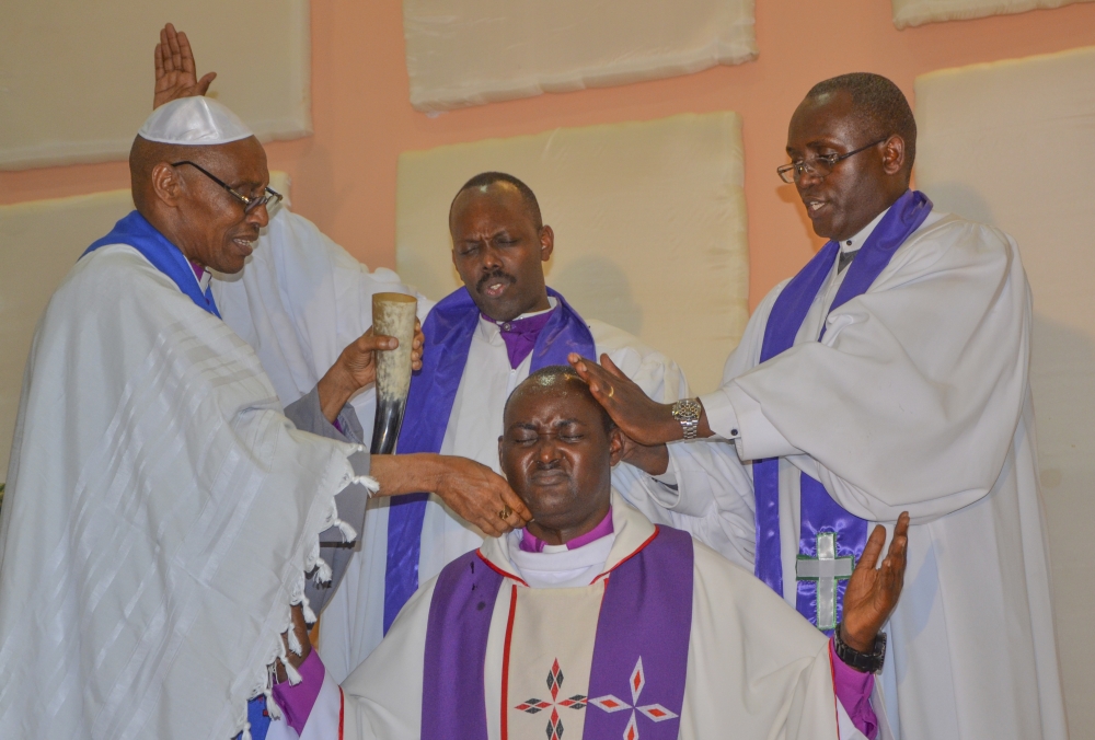 Apostle Charles Rwandamura (left) anointing Bishop Rugamba of Betsaida Holy Church during an enthronement in Kigali on September 13, 2014. Photo by Sam Ngendahimana