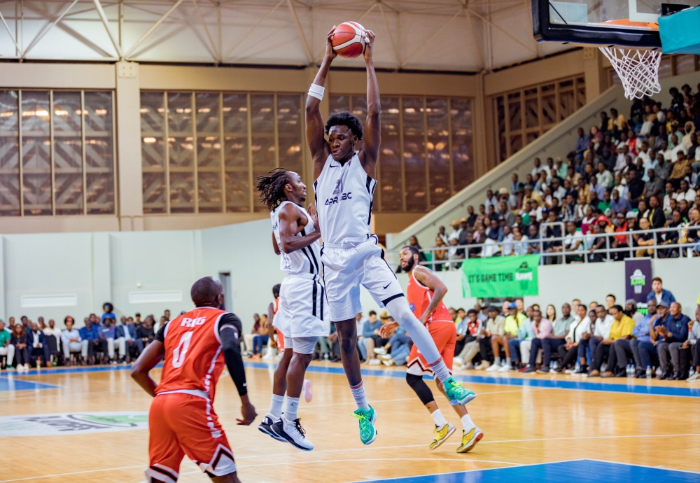 Star center Aliou Diarra jumps high to claim the ball during APR&#039;s 66-61 victory over REG on Wednesday night. APR advanced to the finals after winning the series 3-0-Photos by Dan Gatsinzi