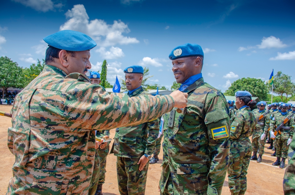 UNMISS Force Commander Lt Gen Mohan Subramanian   gives  the medals Rwandan peacekeepers on Thursday, September 5. Courtesy