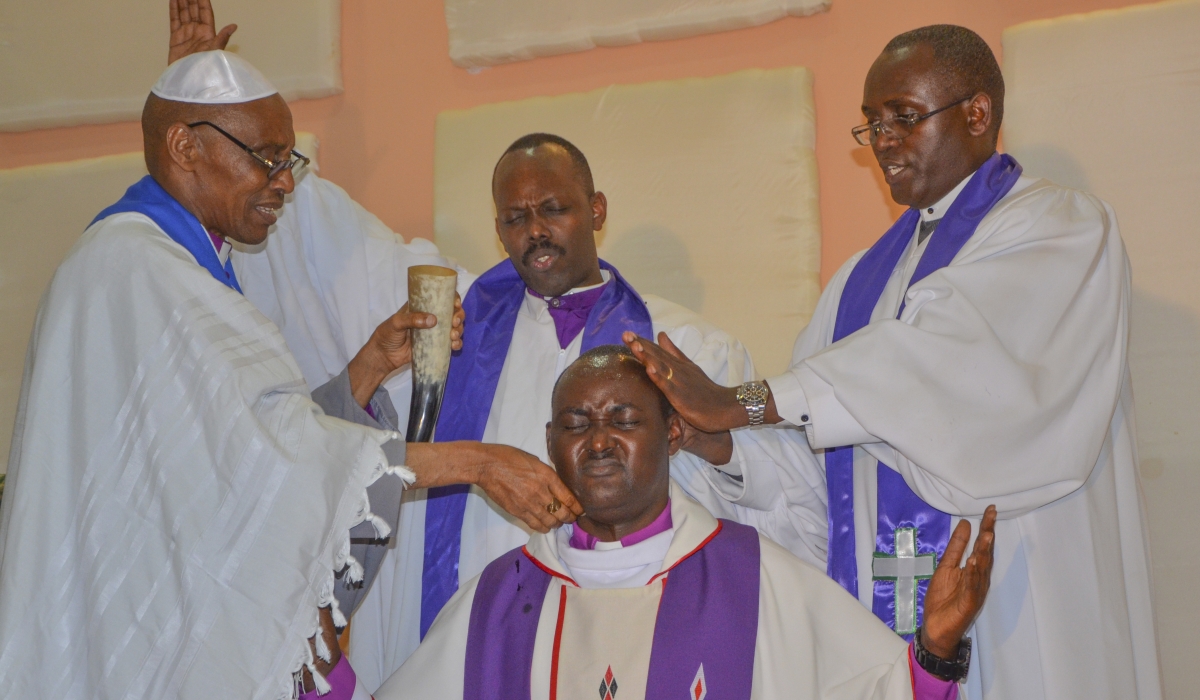 Apostle Charles Rwandamura (left) anointing Bishop Rugamba of Betsaida Holy Church during an enthronement in Kigali on September 13, 2014. Photo by Sam Ngendahimana