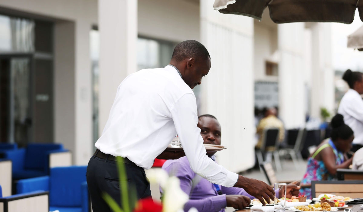 A waiter serves a customer in Kigali.  (Sam Ngendahimana)