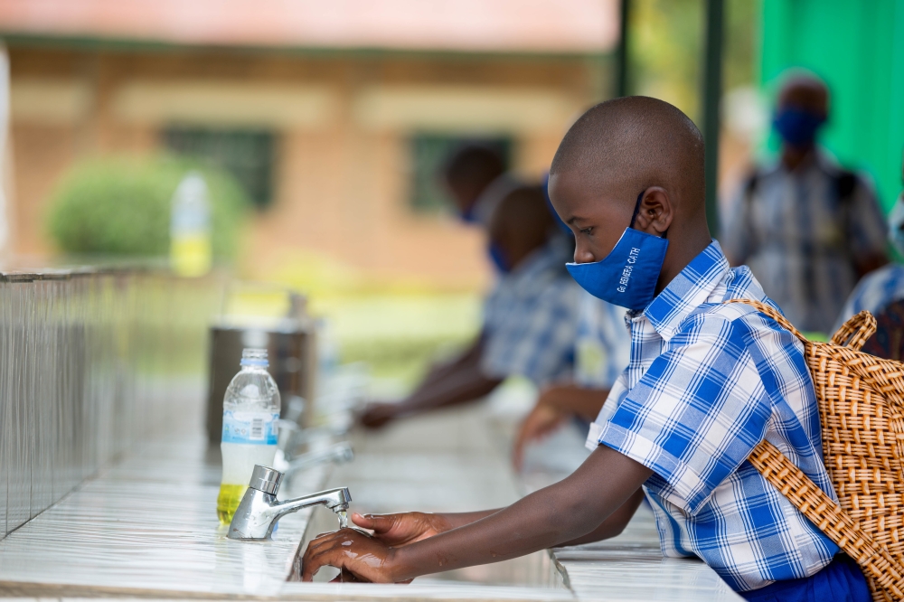 Children wash their hands to prevent the spread of Covid 19 at Groupe Scolaire Remera Catholique in 2021. Dan Nsengiyumva