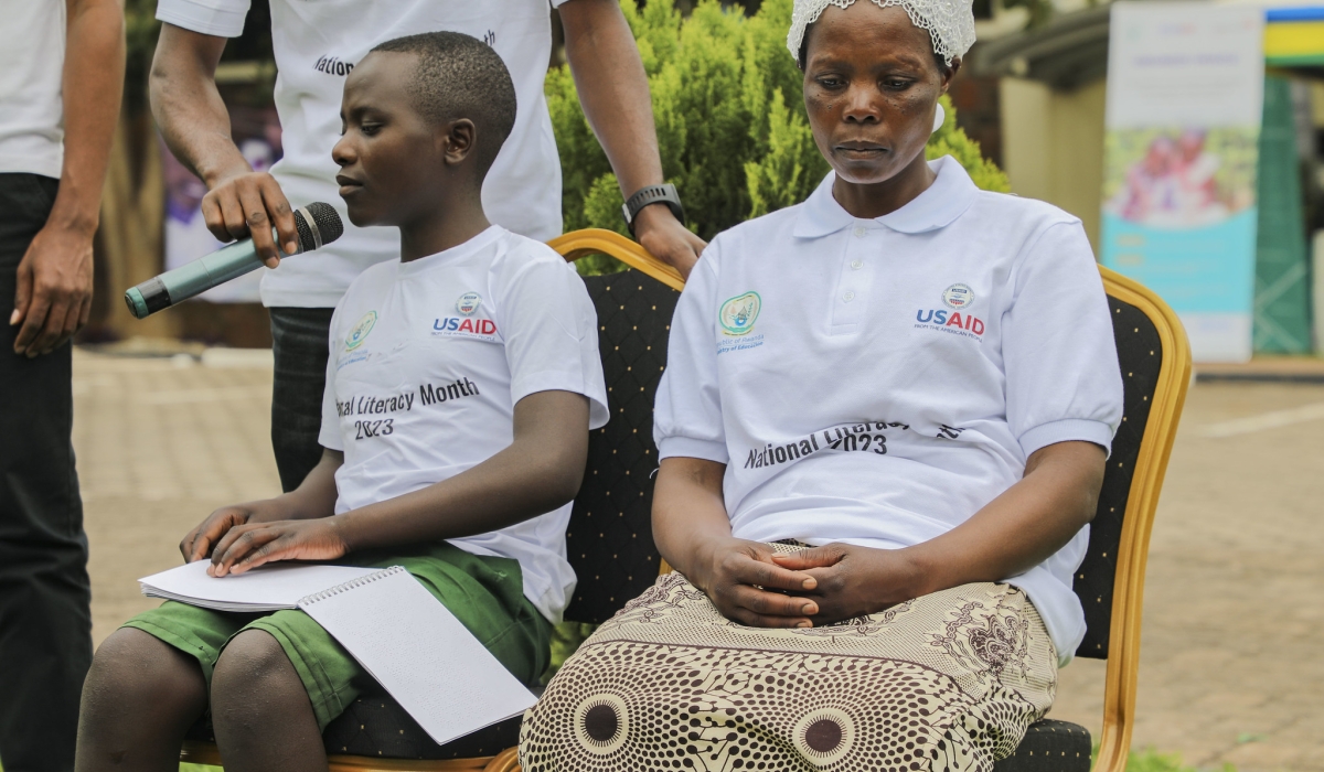 A child with disablity reading a school textbook in Braille format at the event. REB initiated a project to translate all school textbooks into Braille format.