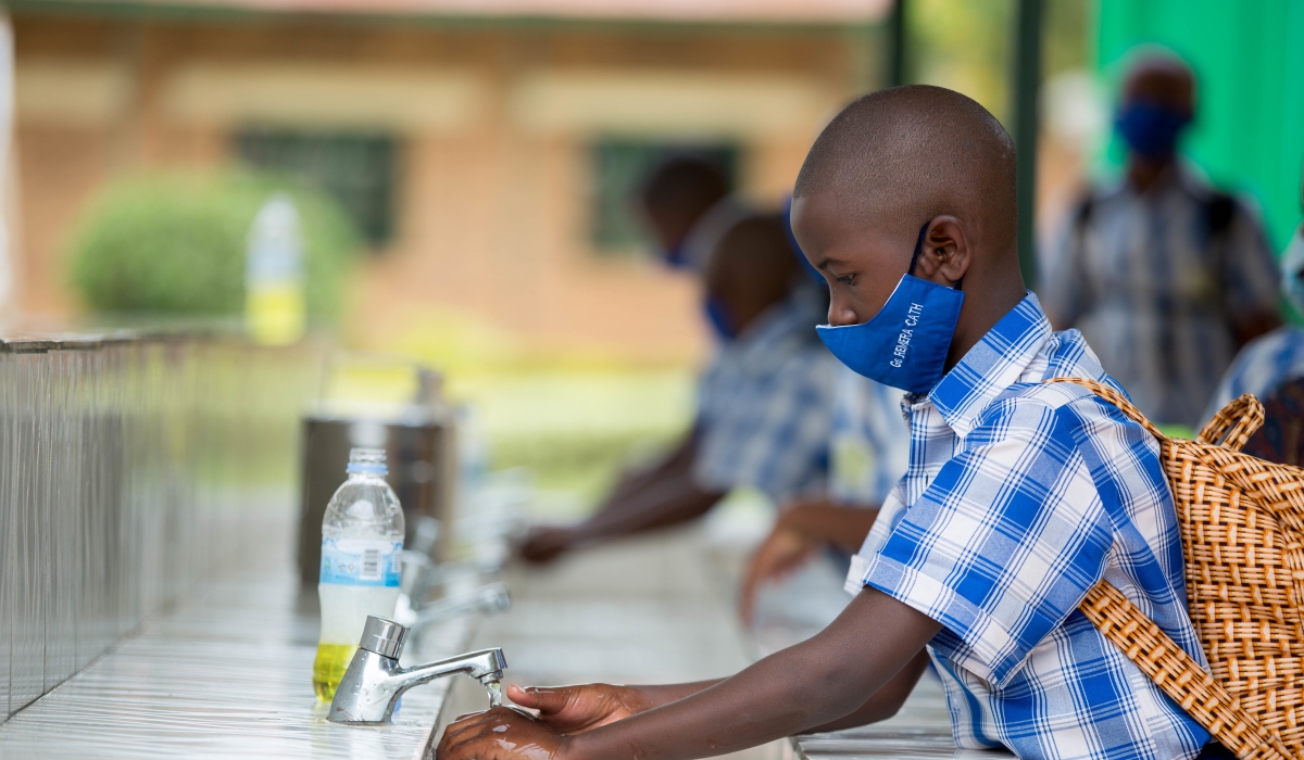 Children wash their hands to prevent the spread of Covid 19 at Groupe Scolaire Remera Catholique in 2021. Dan Nsengiyumva