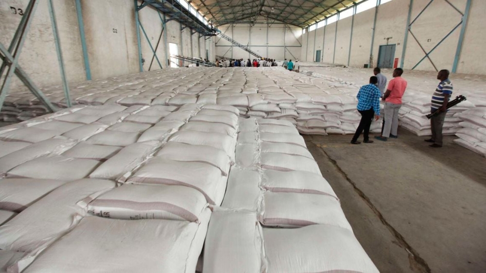 Workers arrange bags of sugar at Mumias Sugar Company store in Western Kenya on September 28, 2018.