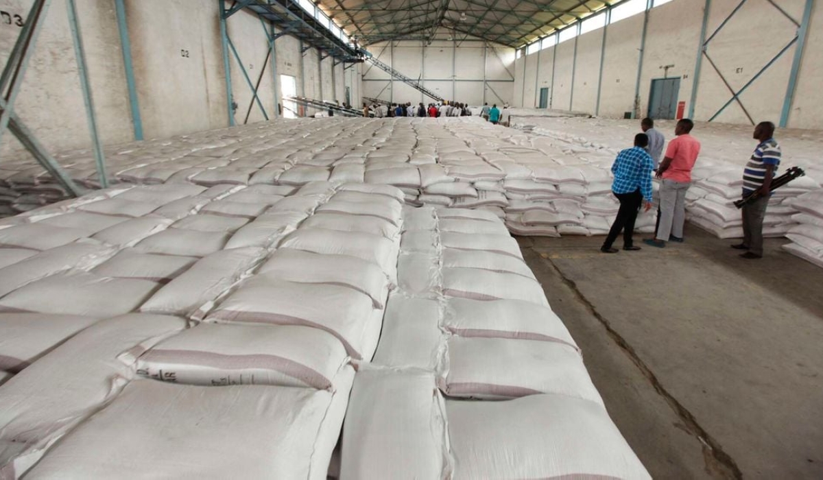 Workers arrange bags of sugar at Mumias Sugar Company store in Western Kenya on September 28, 2018.