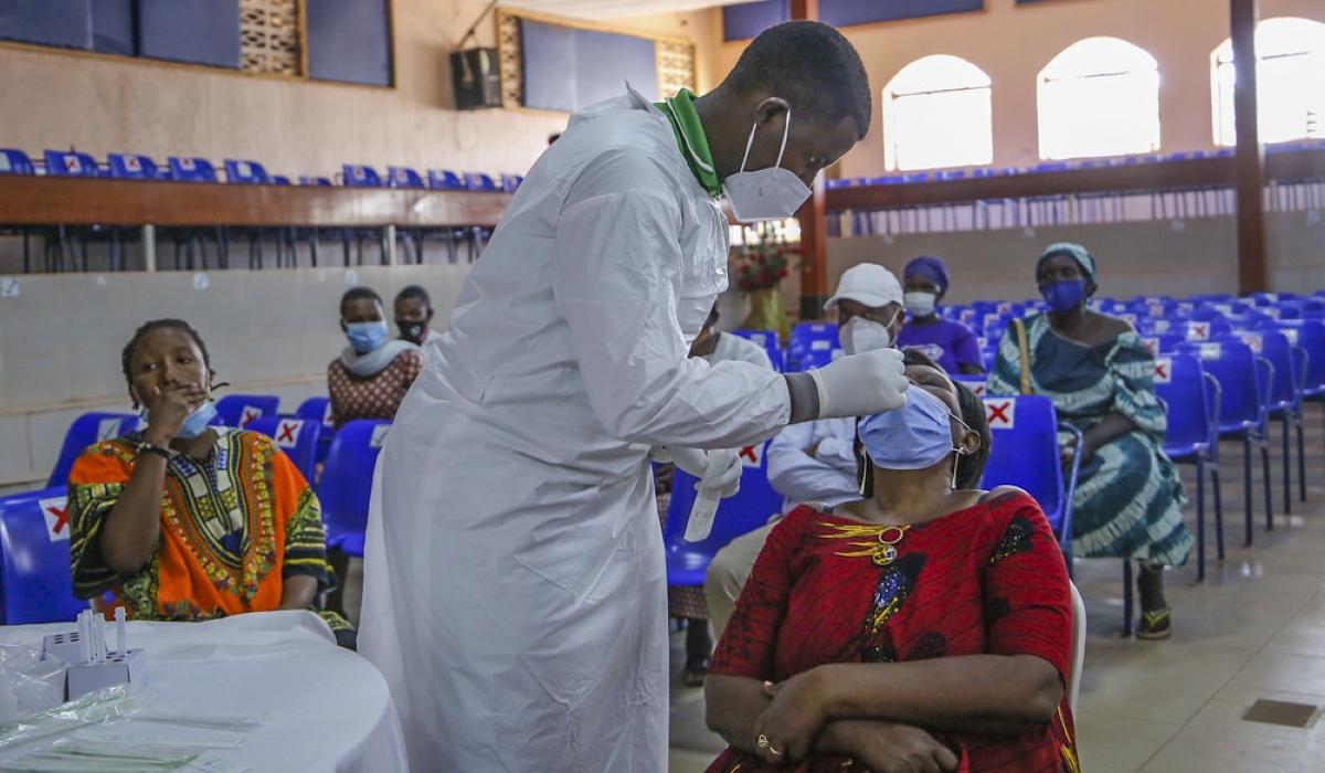 A health worker during a mass testing exercise of Covid 19 in Kigali in 2021. Photo by Craish Bahizi