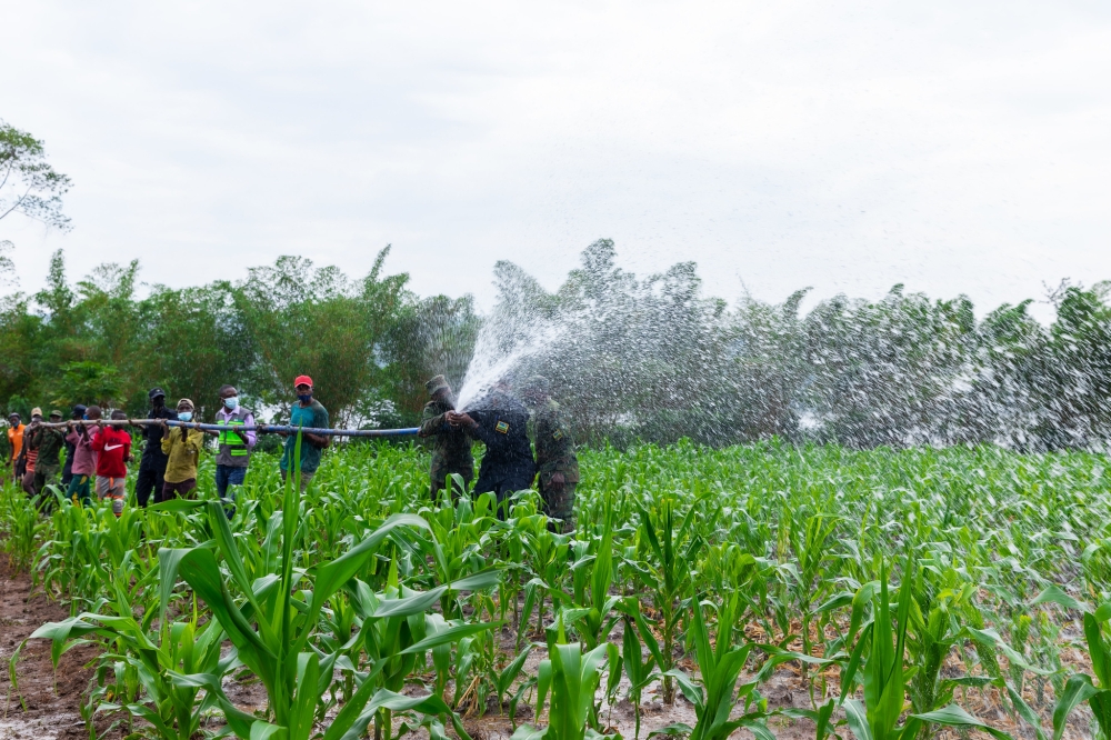 Residents and security officers during an irrigation exercise in  Gatsibo. Rwanda’s agriculture sector is expected to achieve over 6 per cent annual growth. Courtesy