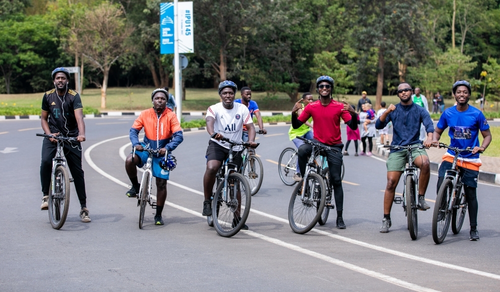 Cyclists meet to ride a few dozen kilometres around Kigali, during car-free day when families take their bikes out to enjoy the traffic-free roads. Photo by Olivier Mugwiza