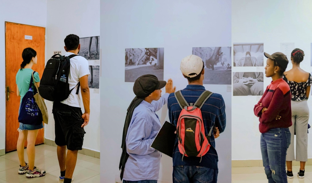 Visitors go through different visuals showcased at Le Mal du Corps exhibition in Kigali. Courtesy