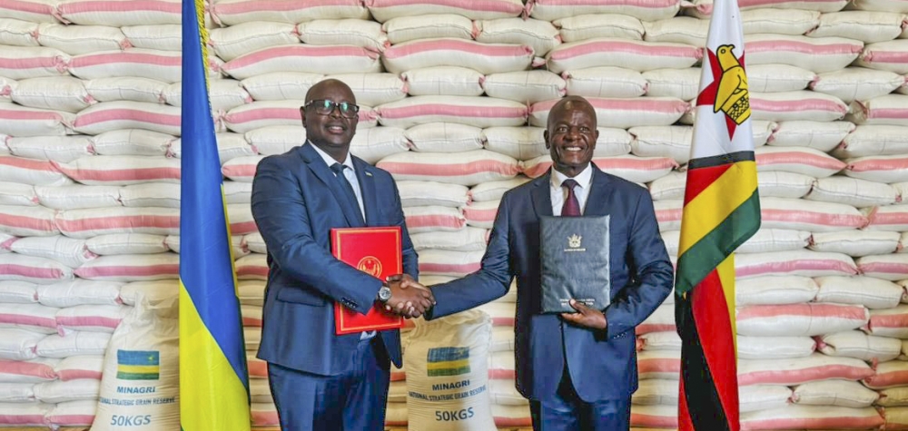 Rwanda’s Ambassador to Zimbabwe James Musoni hands over the donation to Zimbabwe’s Minister of Local Government and Public Works Daniel Garwe at the Grain Marketing Board’s Aspindale Depot in the capital Harare.