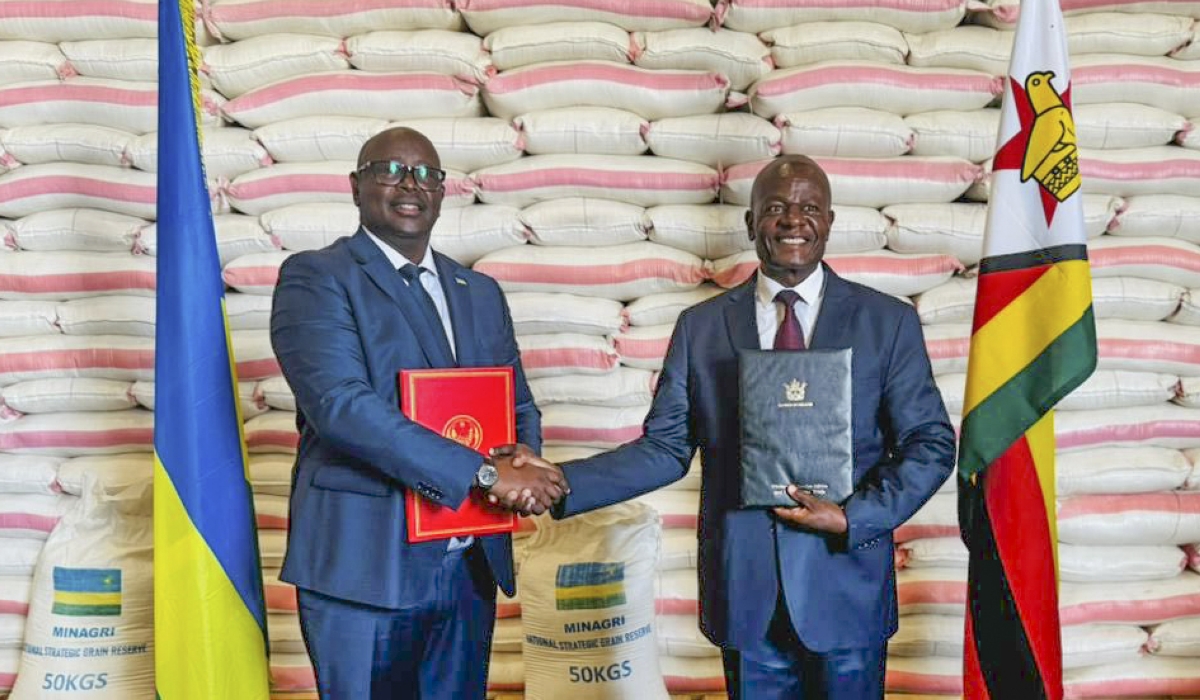 Rwanda’s Ambassador to Zimbabwe James Musoni hands over the donation to Zimbabwe’s Minister of Local Government and Public Works Daniel Garwe at the Grain Marketing Board’s Aspindale Depot in the capital Harare.