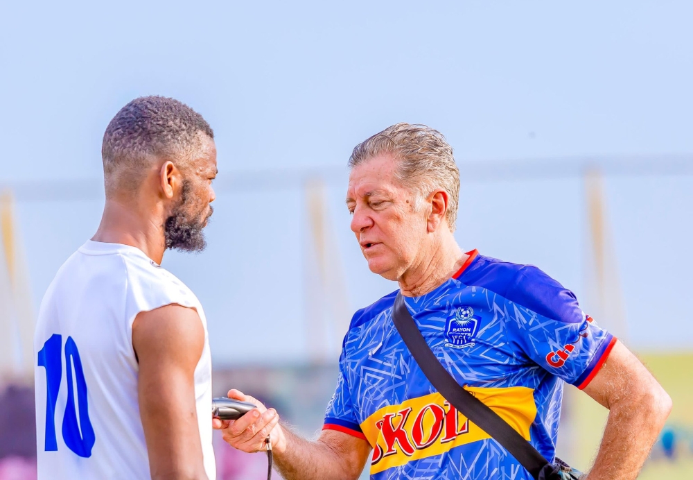 Rayon Sports head coach Robertinho Oliveira Goncalves do Carmo gives instruction to a player during a training session at Nzove football pitch. Courtesy