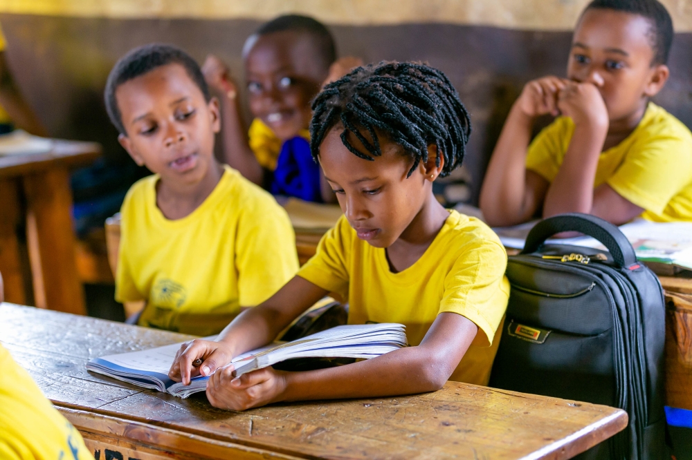 A child reads a book at GS Camp Kigali in Nyarugenge District. September is National Literacy Month. Craish Bahizi