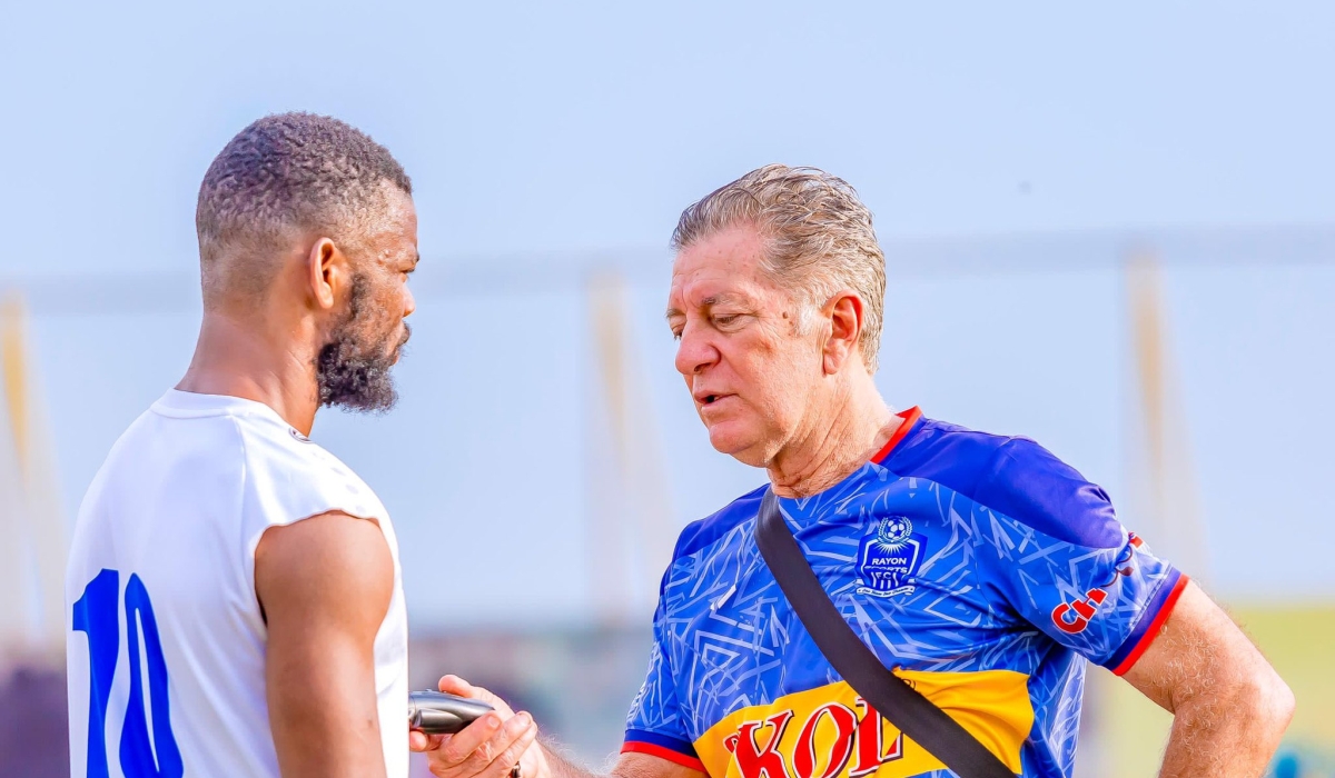 Rayon Sports head coach Robertinho Oliveira Goncalves do Carmo gives instruction to a player during a training session at Nzove football pitch. Courtesy