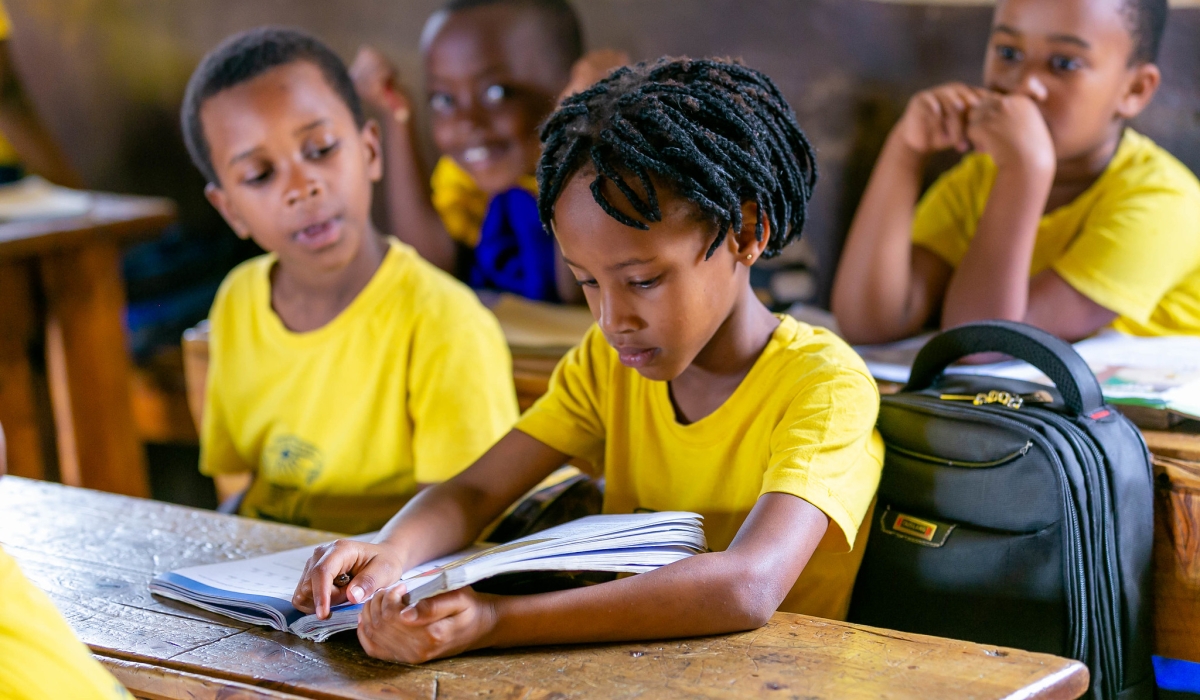 A child reads a book at GS Camp Kigali in Nyarugenge District. September is National Literacy Month. Craish Bahizi