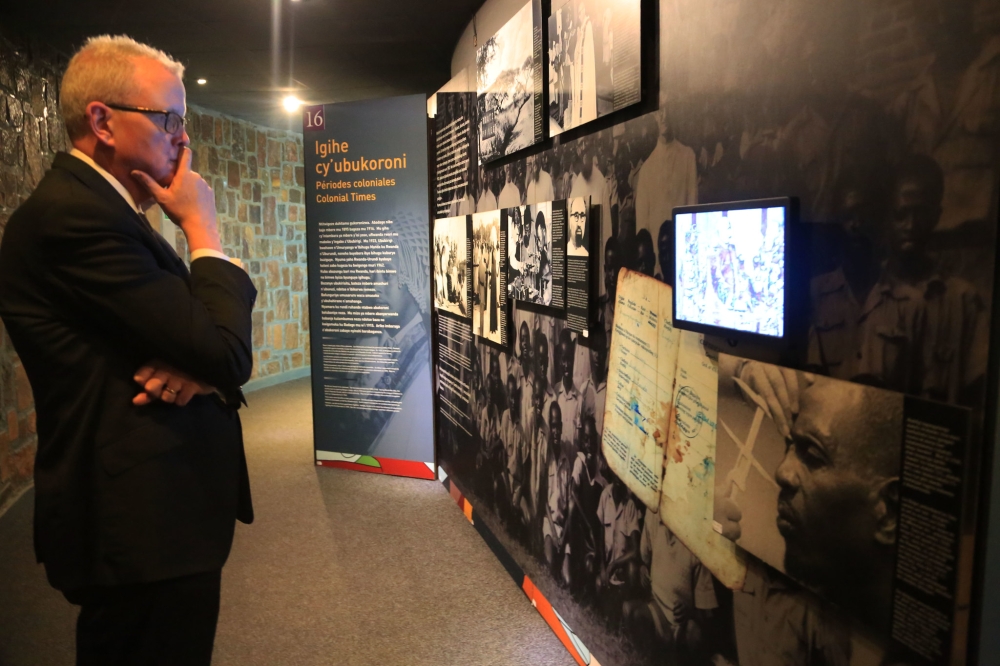 A visitor watches a video on Rwandan history during his tour at Kigali Genocide Memorial. Photo by Sam Ngendahimana