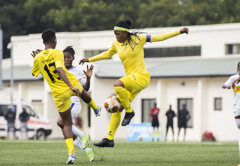 AS Kigali women players vie for the ball against Rayon Sports player during a past game at Kigali Pele Stadium. Photo by Craish Bahizi