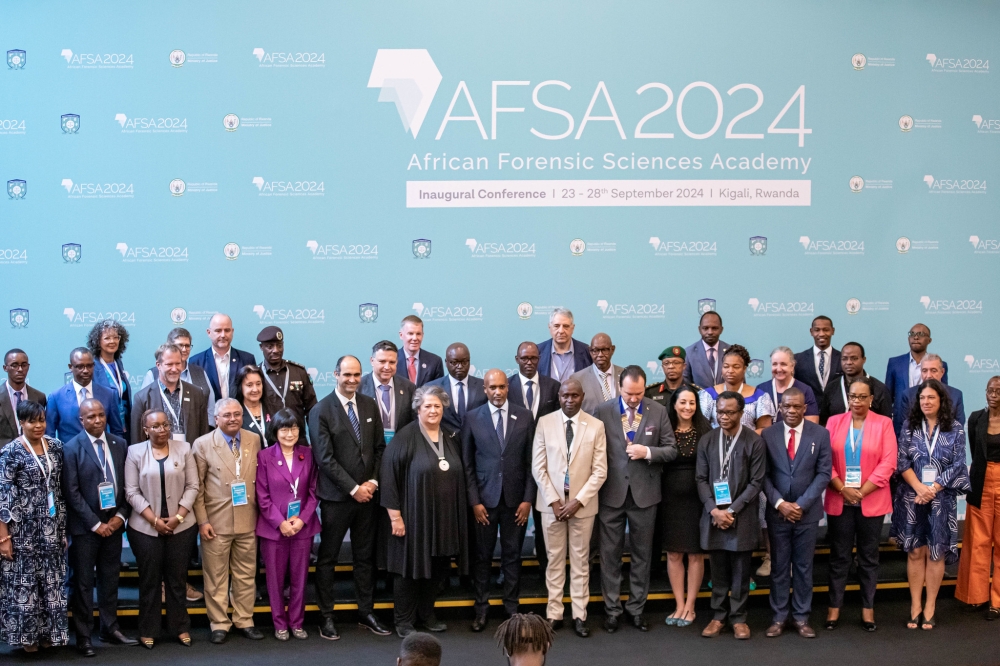 Officials and delegates pose for a group photo at the opening session of the conference at Kigali Convention Centre on September 25.