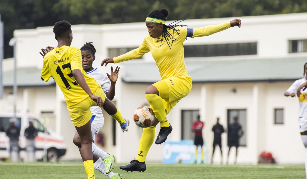 AS Kigali women players vie for the ball against Rayon Sports player during a past game at Kigali Pele Stadium. Photo by Craish Bahizi