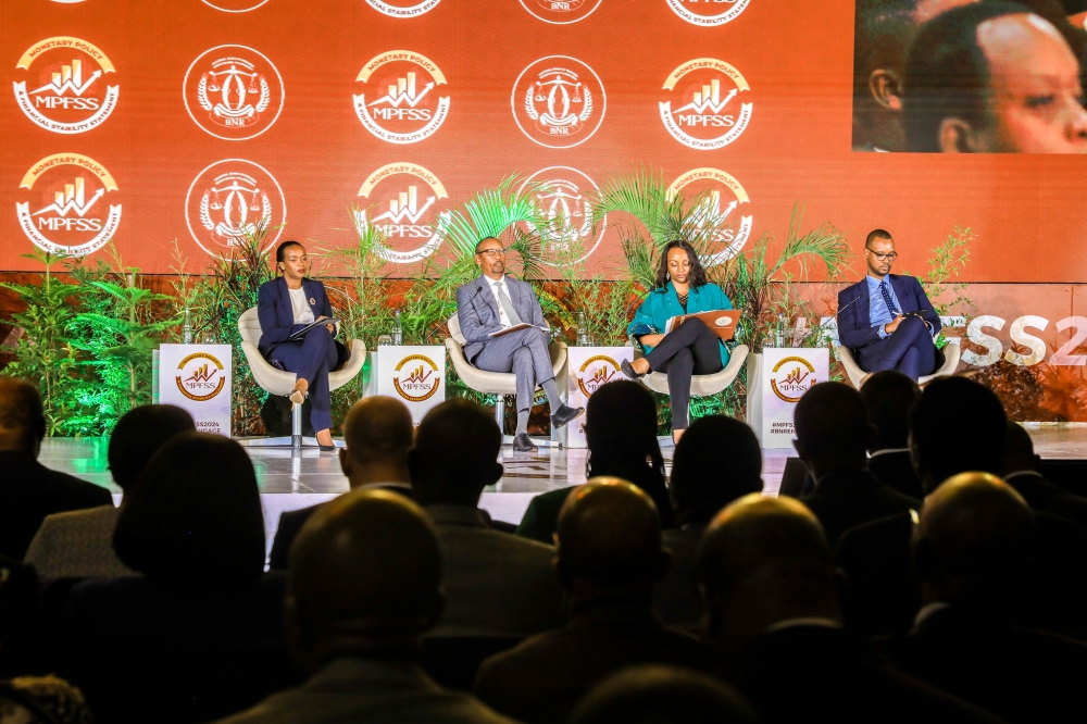 Delegates follow a panel discussion of Central Bank Governor John Rwangombwa, and his deputy Soraya Hakuziyaremye and other experts at the event.