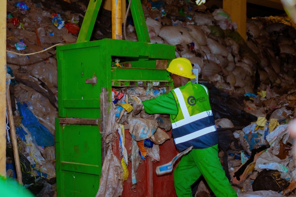 Workers from Green Care Rwanda Ltd sort some plastic waste that are recycled to produce different items, including pavers. Courtesy