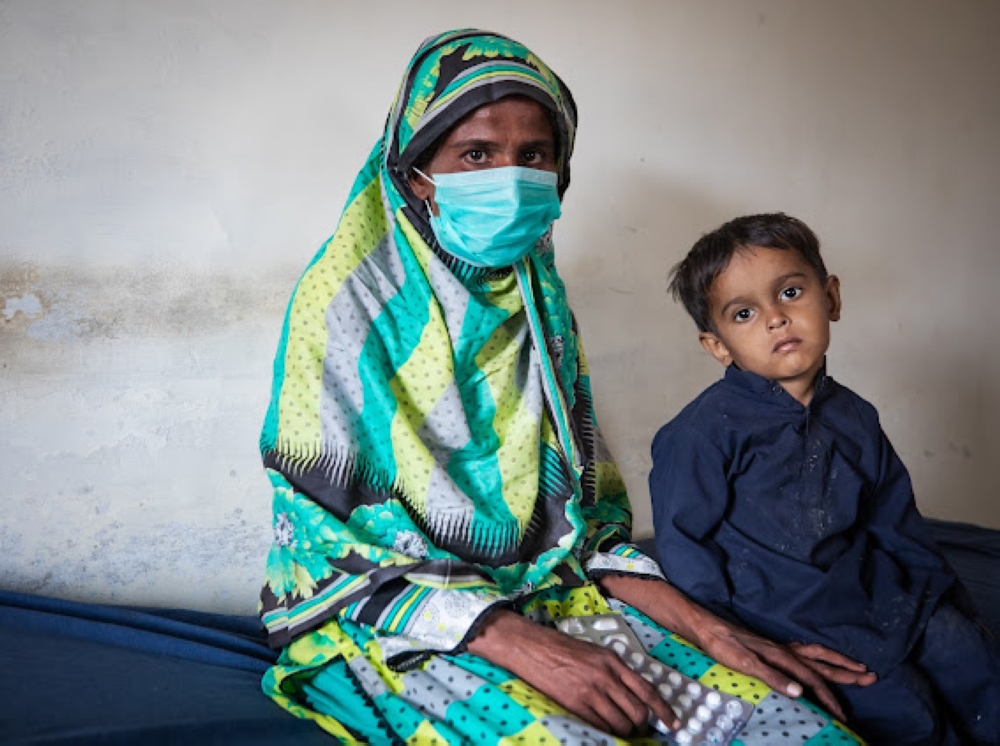 Shireen Piyar Ali, a resident of Thatta, Sindh, Pakistan, with her son, Muhammad Ahan, at a clinic. (21st November, 2023)