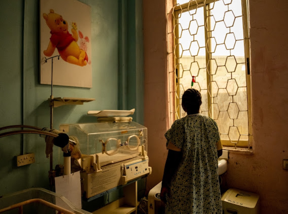 Adepeju Adebajo looks out the window as she awaits her son's discharge from the  Massey Children's Hospital, Lagos on the 26th January, 2024. She was admitted pre-term at 35 weeks old and her baby was incubated at the hospital. To combat an infection, he was given Cefotaxime antibiotics but it didn't work at the completion of dosage so prescribed Meropenem. Her baby is healthy and has been taken out of the incubator, and currently awaits discharge.