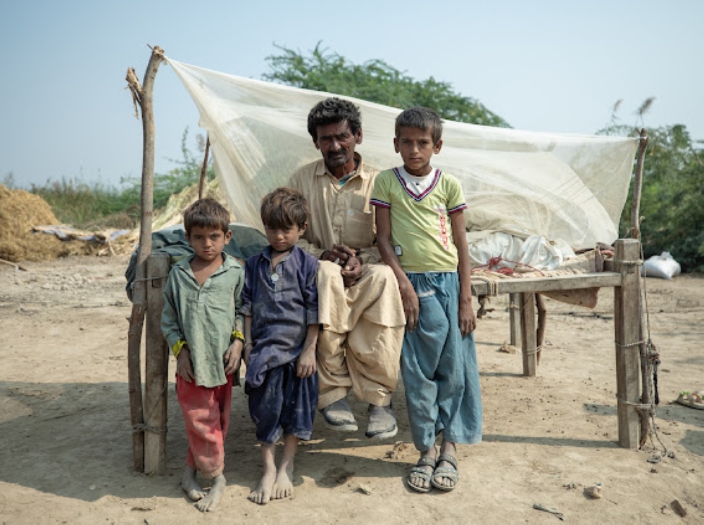 Rab Dino, a local resident of Village Hussain Dafrani, Thatta, Sindh, Pakistan at an open field he calls home along with his deceased brother's children whom he cares for. (21st November, 2023)