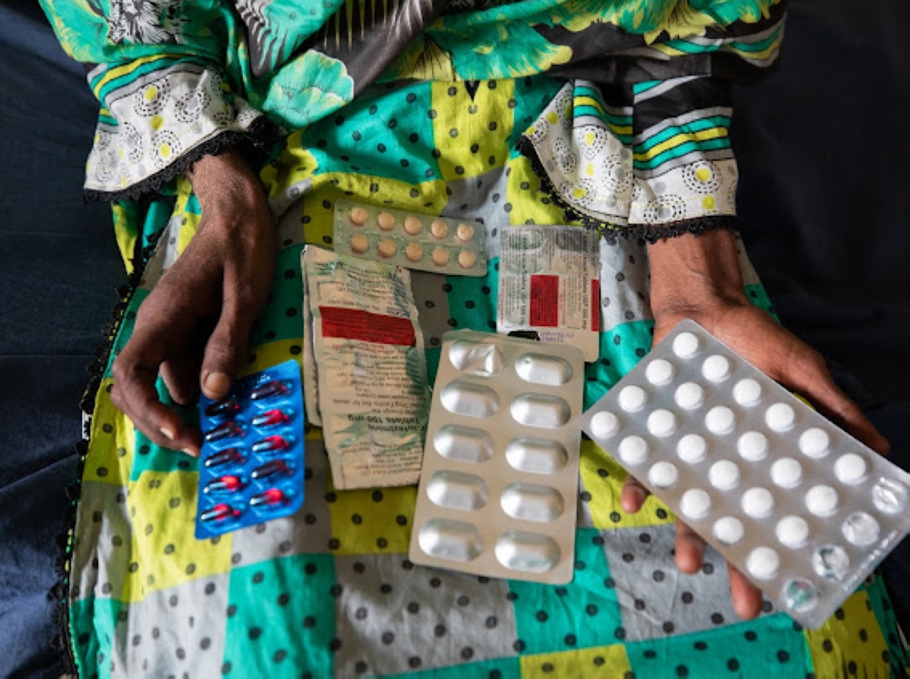 Shireen Piyar Ali, a resident of Thatta, Sindh, Pakistan, holds up her medicines at a clinic. (21st November, 2023)