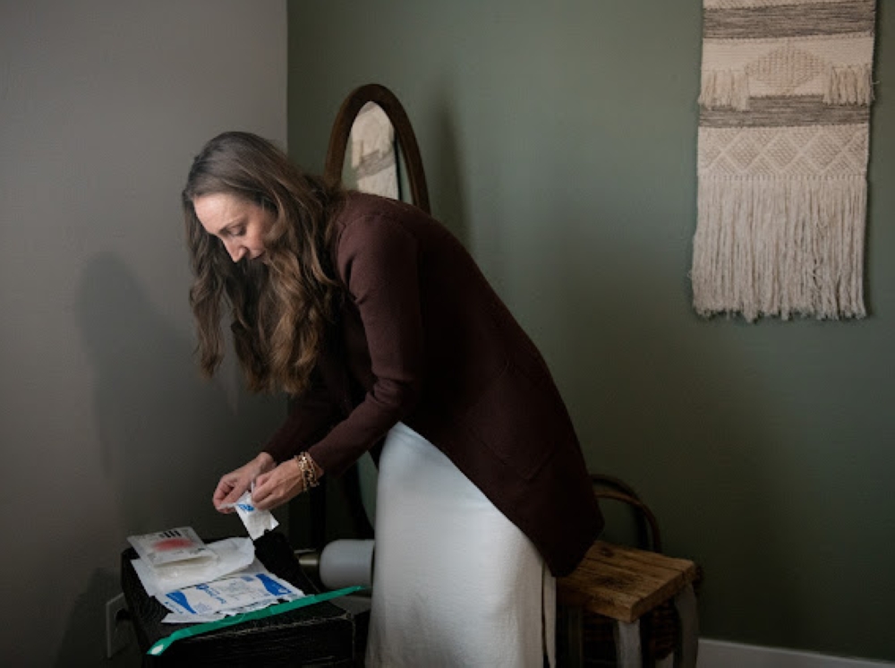 Autumn Mitchell sets up a station in her room to inject local antibiotics for her drug resistant urinary tract infection at home on August 9, 2024 in Phoenix, Arizona, U.S.