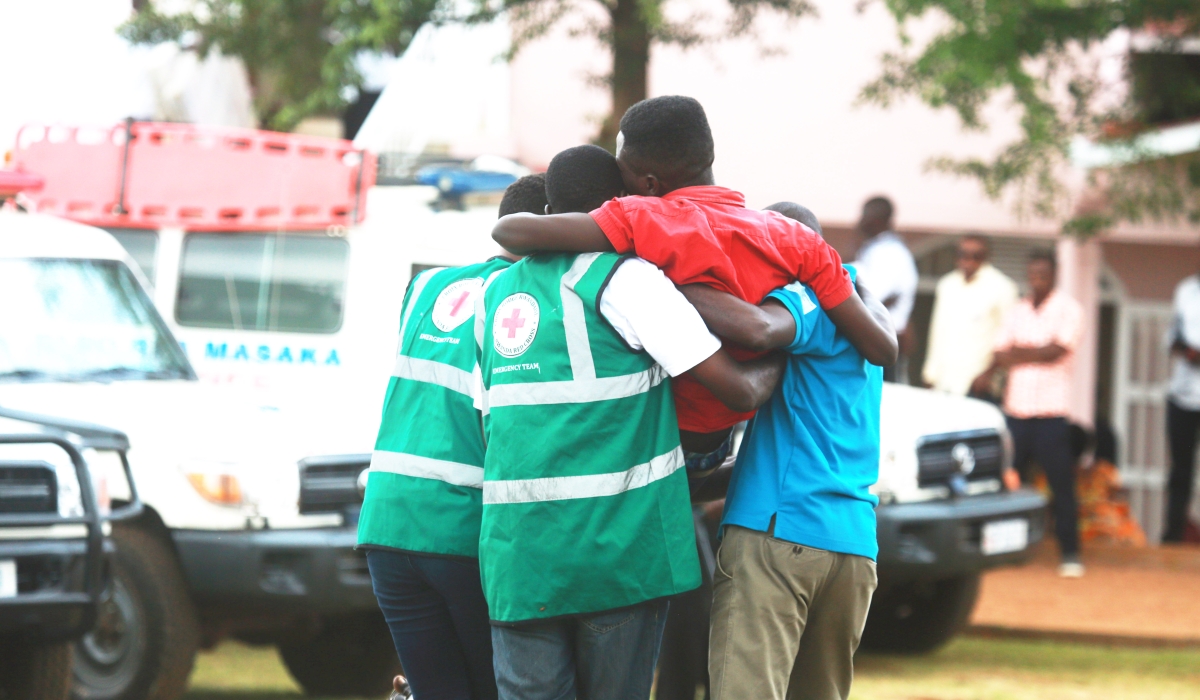 Volunteers help a trauma victim during a commemoration event at Kicukiro Nyanza Genocide Memorial on May 4, 2019. Sam Ngendahimana