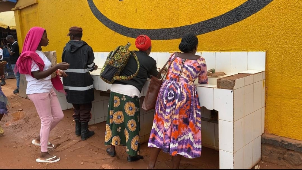 People wash their hands at Kimironko market. Photos by Joan Mbabazi