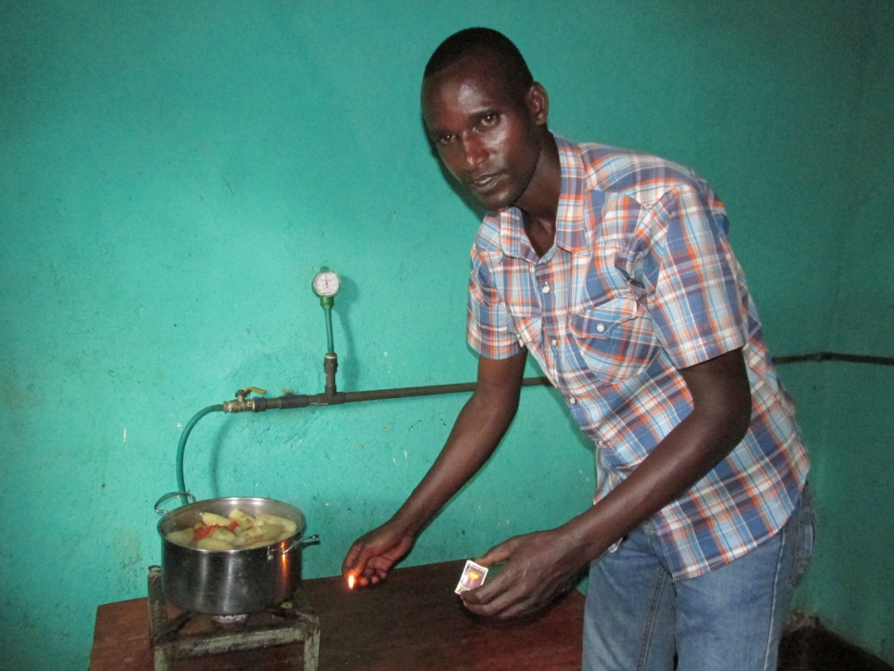 Resident using Biogas to cook his food in Gisagara District. Rwanda is set to restore 70 per cent of non-functioning biogas plants (digesters) countrywide in two to three years. File