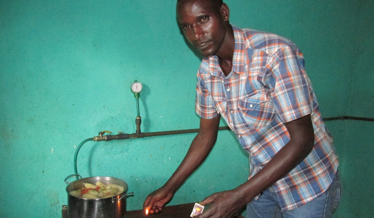 Resident using Biogas to cook his food in Gisagara District. Rwanda is set to restore 70 per cent of non-functioning biogas plants (digesters) countrywide in two to three years. File