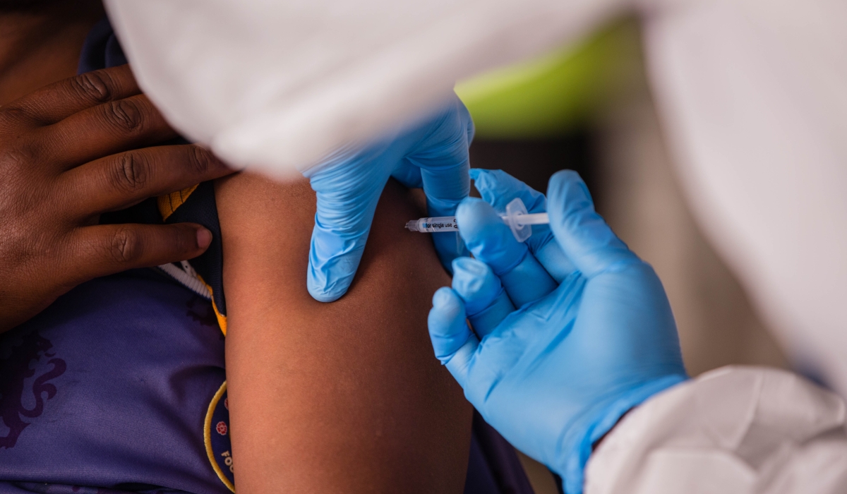 A health worker administers a vaccine. American pharmaceutical company Gilead Sciences will donate thousands of vials of its antiviral drug remdesivir to Rwanda. Photo by Craish Bahizi