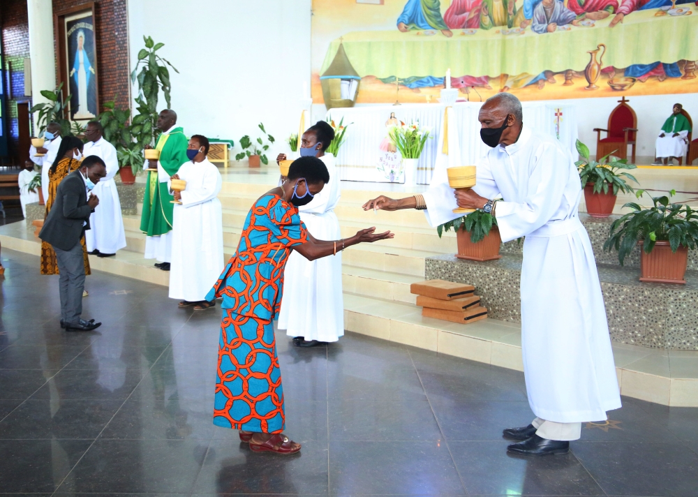 Clerics during the holy communion services at REGINA PACIS catholic church in Remera during the COVID 19 period  on July 19, 2020. Rwanda Governance Board  urged churches and mosques to avoid serving Holy Communion or any similar practices in a manner that could increase the spread of the Marburg virus. Photo by Craish Bahizi