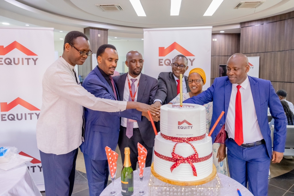 Equity Bank Rwanda officials and customers cut a cake as the bank kicked off its annual Customer Service Week celebration on Monday, October 7. Courtesy