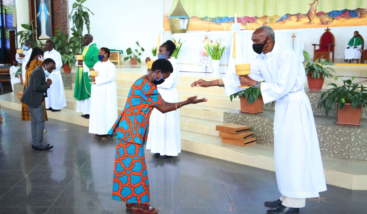 Clerics during the holy communion services at REGINA PACIS catholic church in Remera during the COVID 19 period  on July 19, 2020. Rwanda Governance Board  urged churches and mosques to avoid serving Holy Communion or any similar practices in a manner that could increase the spread of the Marburg virus. Photo by Craish Bahizi