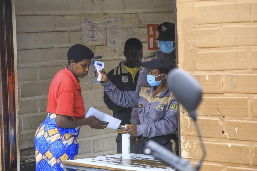 Security officers screen a woman before entering CHUK hospital in Kigali on Tuesday, October 8. Photo by Emmanuel Dushimimana