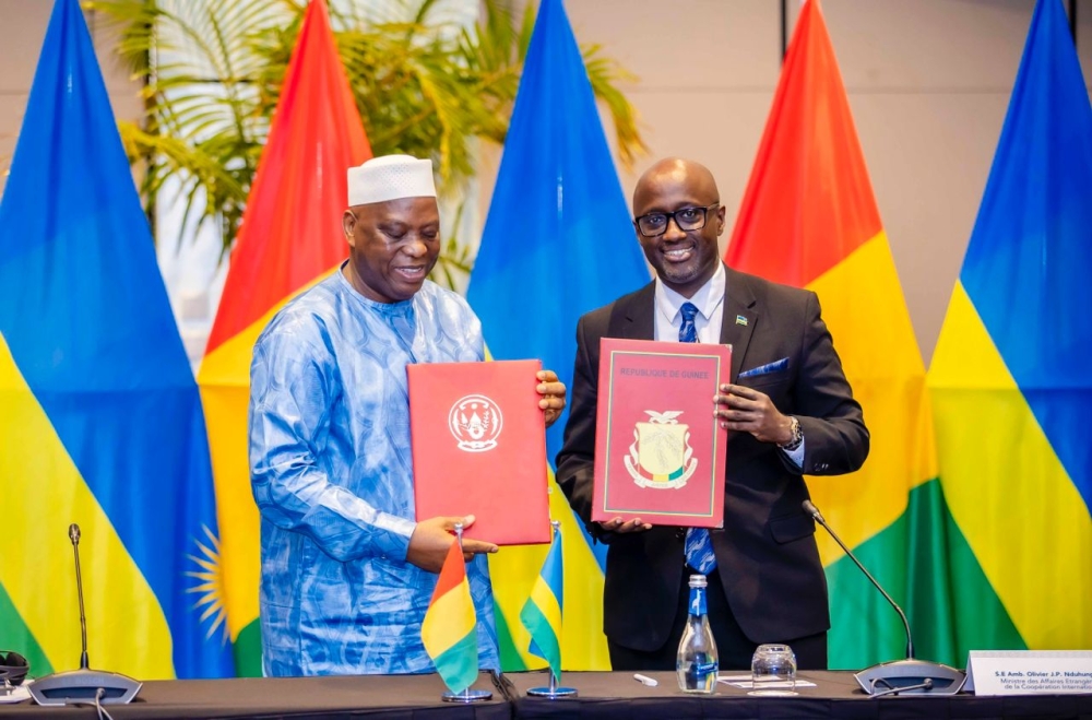 Minister of Foreign Affairs and International Cooperation Olivier Nduhungirehe and his Guinean counterpart Morissanda Kouyate, during the signing ceremony in Kigali on October 9. Craish Bahizi