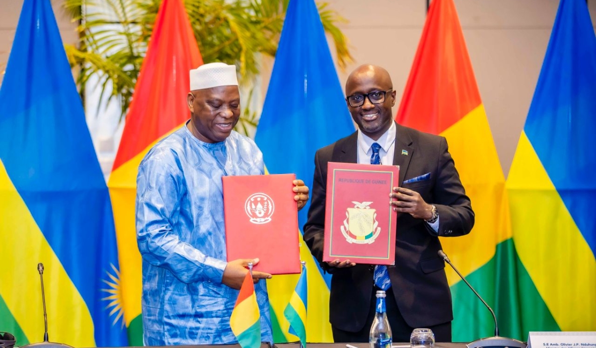 Minister of Foreign Affairs and International Cooperation Olivier Nduhungirehe and his Guinean counterpart Morissanda Kouyate, during the signing ceremony in Kigali on October 9. Craish Bahizi