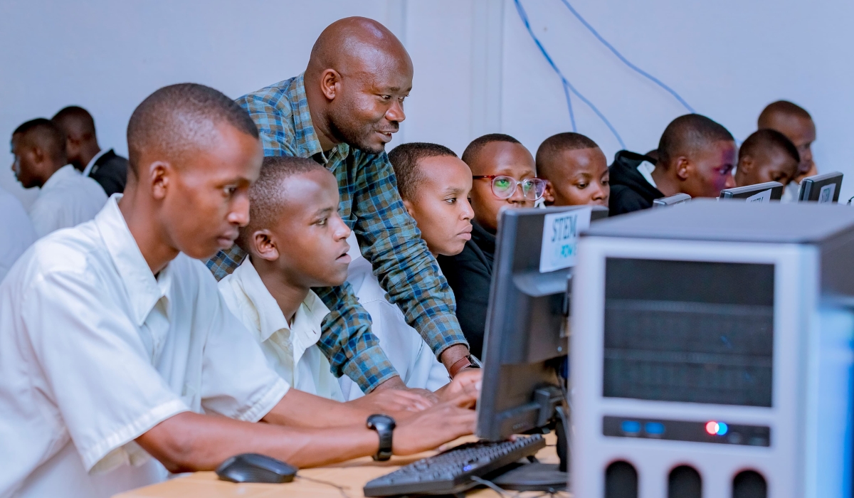 A teacher helps students at STEM centre. According to the officials, STEMpower,  has established a network of eight operational STEM centres in Rwanda. Courtesy