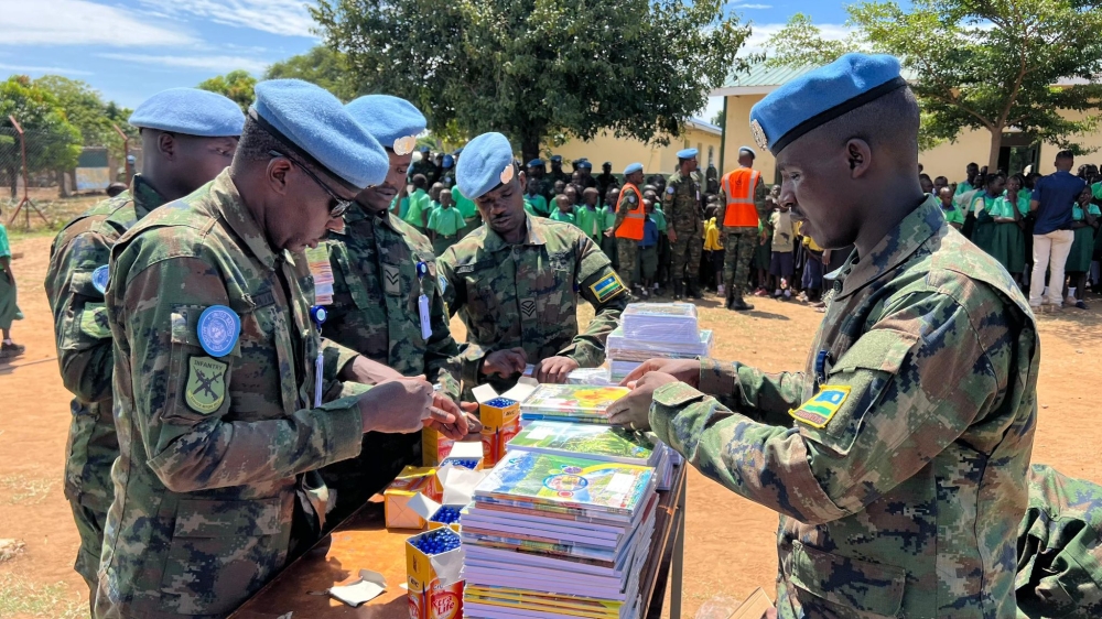 Rwandan peacekeepers from RwanBatt1 sort scholastic materials during a handover event at Kapuri Primary School, on the outskirts of South Sudan’s capital Juba on Monday, October 14. The peacekeepers, serving under the United Nations Mission in South Sudan (UNMISS), took part in humanitarian efforts to uplift local communities. Photo: Davis Higiro