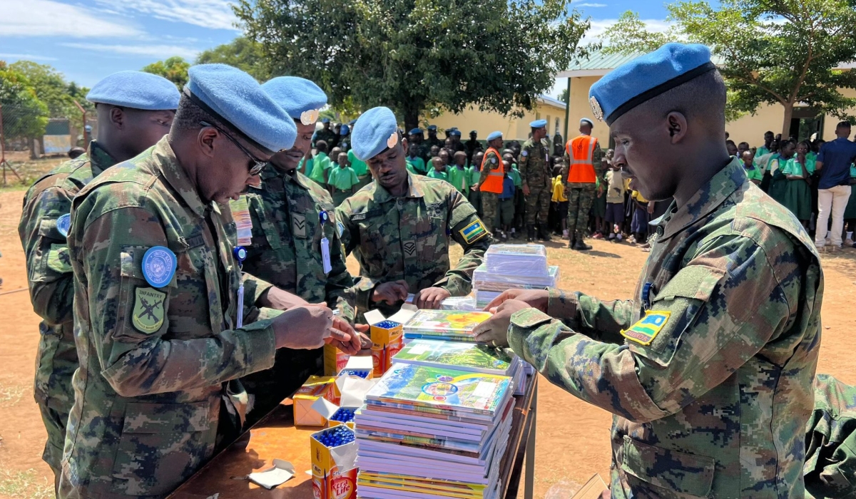 Rwandan peacekeepers from RwanBatt1 sort scholastic materials during a handover event at Kapuri Primary School, on the outskirts of South Sudan’s capital Juba on Monday, October 14. The peacekeepers, serving under the United Nations Mission in South Sudan (UNMISS), took part in humanitarian efforts to uplift local communities. Photo: Davis Higiro