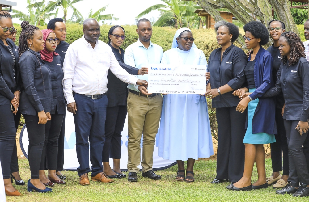 I&M Bank Rwanda Plc staff hands over their support to Rubungo Health Centre  to support malnourished children in Kibenga cell, Ndera sector, Gasabo District on October 16. Photos by Craish Bahizi