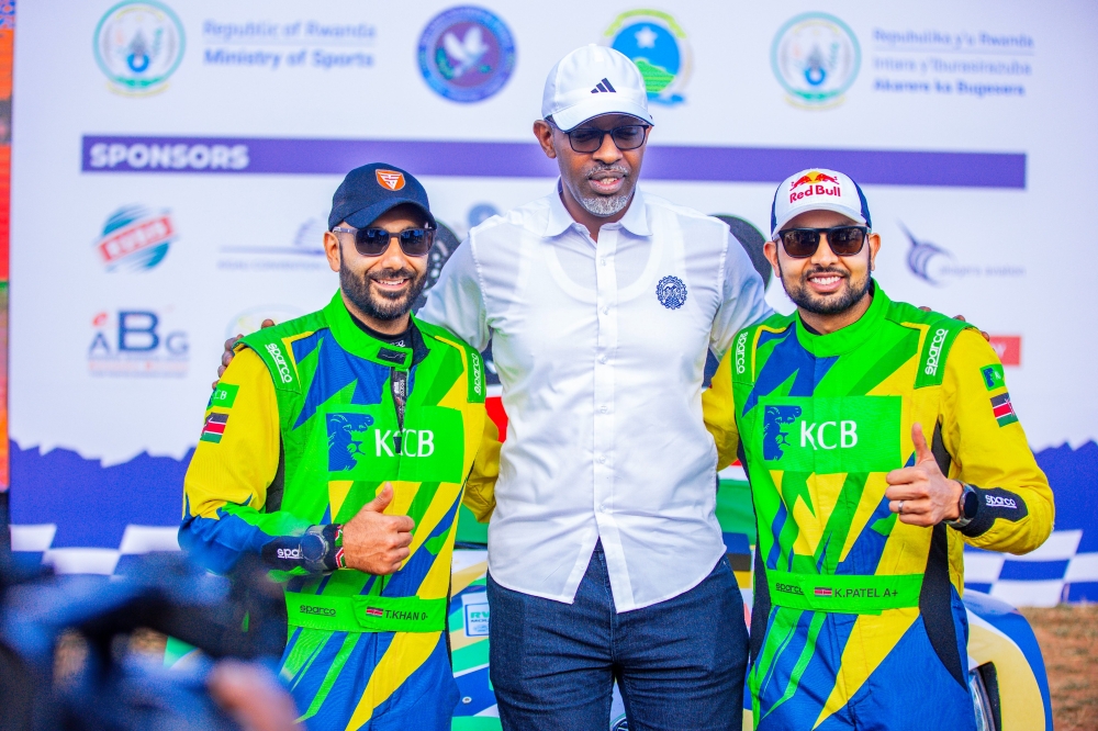 Minister of Sports Richard Nyirishema poses for a photo with Kenyan driver Karan Patel and his co-driver Tauseef Khan as they retained the Rwanda Mountain Gorilla Rally title on Sunday. Courtesy